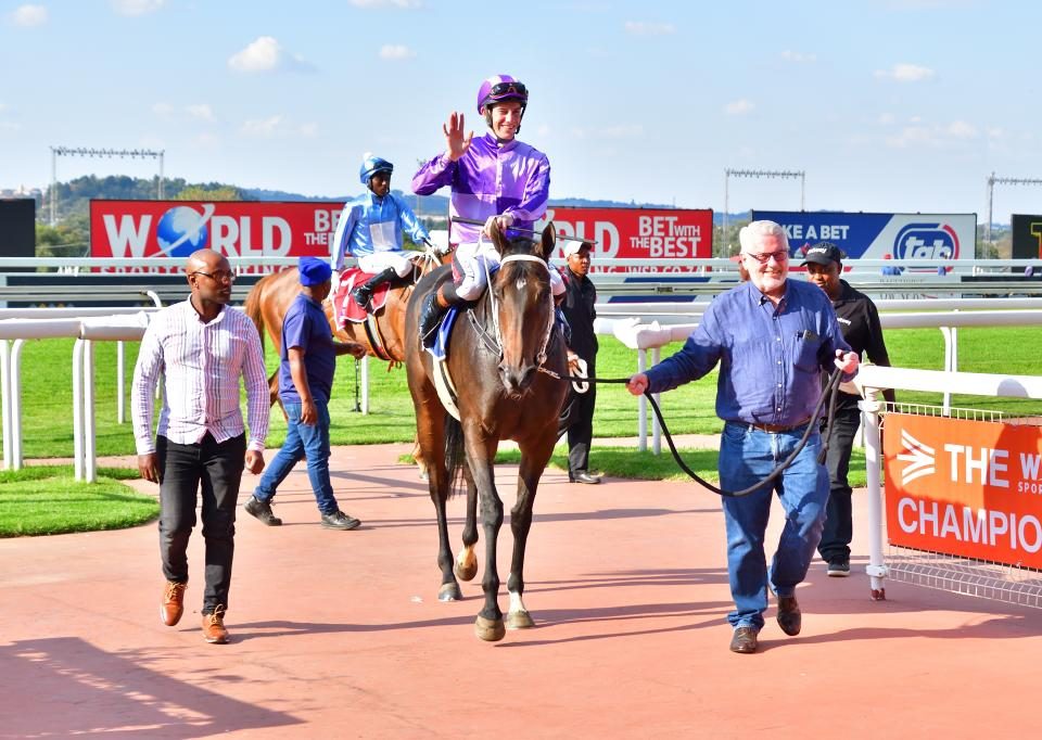 Mike Destombes leading in his filly, Bold Act.
